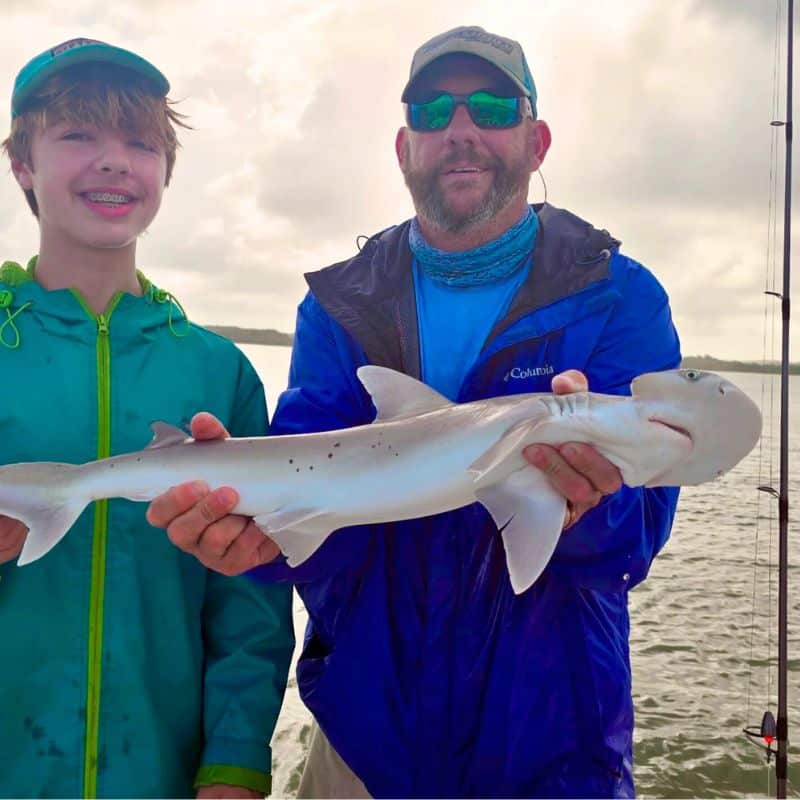 Father and son fishing together on Cast Away boating charter