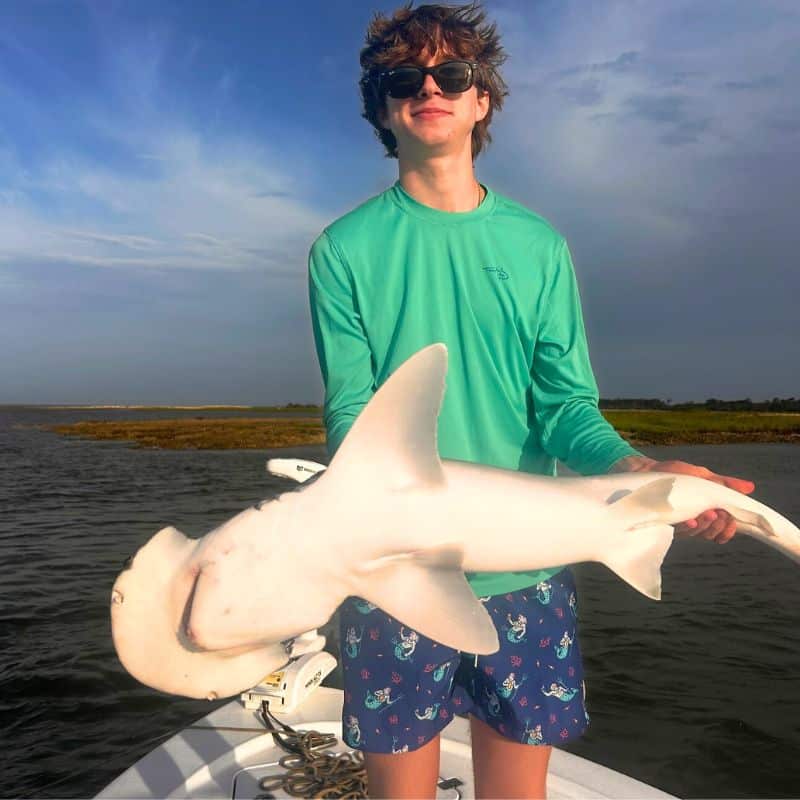 Teen holding fish on Cast Away fishing and boating charter