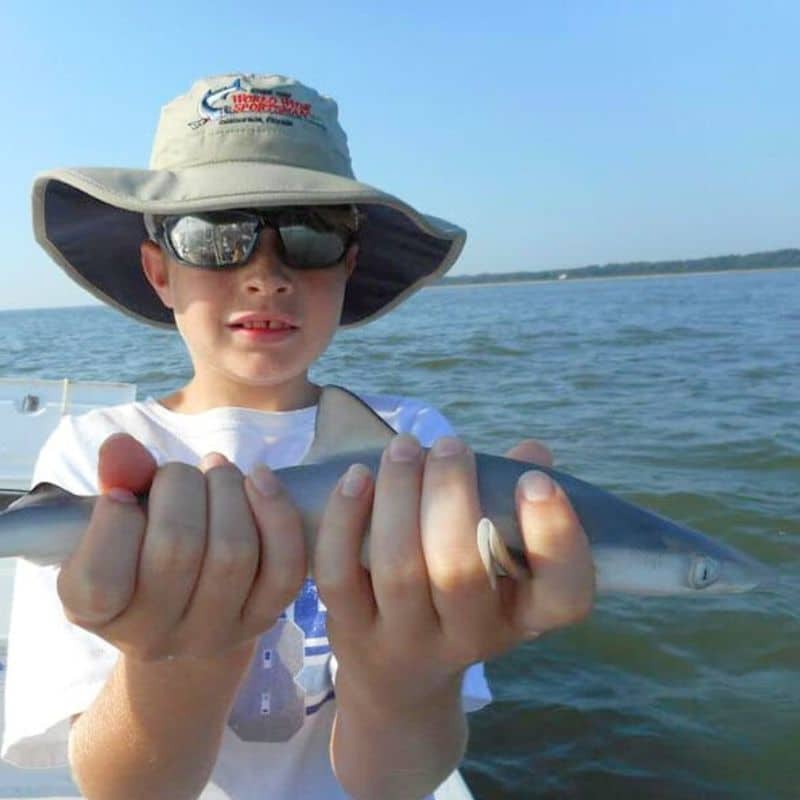 Young angler holding fish on Beaufort SC fishing charter