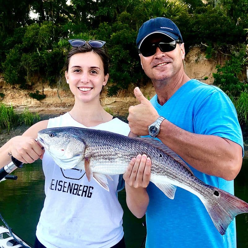 Couple holding catch on Sea Islands fishing charter