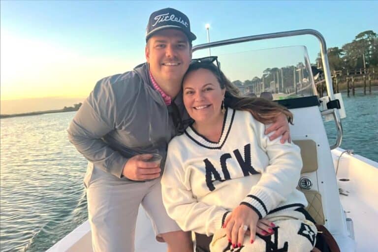 A man and a woman enjoying a boat ride at sunset in Beaufort SC
