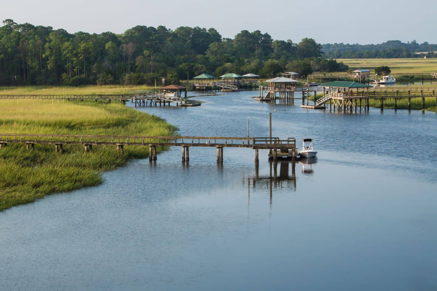 A Lowcountry landscape aerial view of docks and surrounding trees with marsh