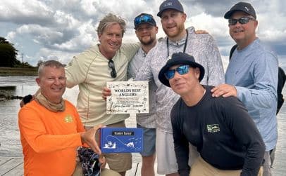 A group of men holding a "Best Angler" award from Cast Away's fishing tourney
