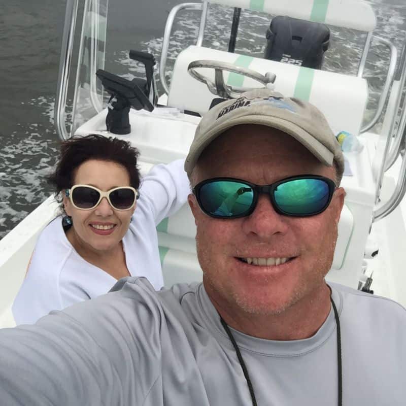 Capt. Tim and Mrs. Capt. Tim smile for a selfie aboard their boat