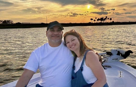 A couple enjoy a romantic sunset cruise aboard Cast Away boat